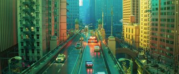 Movie still from “The Lego Batman Movie” (2017), directed by Chris McKay – Cars driving down a street in a large city at night; Extreme Wide shot, High angle