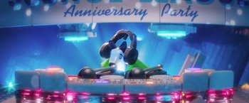 Movie still from “The Lego Batman Movie” (2017), directed by Chris McKay – A person with headphones on a table with a bunch of remotes in front of him; Extreme Close Up shot, High angle