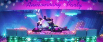 Movie still from “The Lego Batman Movie” (2017), directed by Chris McKay – A toy dog laying on top of a dj booth; Wide shot, High angle