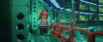 Movie still from “The Lego Batman Movie” (2017), directed by Chris McKay – A lego character is standing next to a red fence; Wide shot, Over the shoulder angle