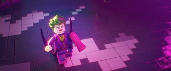 Movie still from “The Lego Batman Movie” (2017), directed by Chris McKay – A lego joker sitting on top of a tile floor; Wide shot, High angle