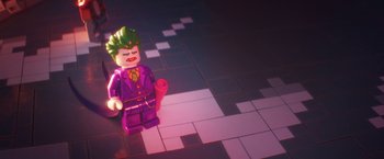 Movie still from “The Lego Batman Movie” (2017), directed by Chris McKay – A lego joker figurine sitting on top of a tile floor; Wide shot, High angle