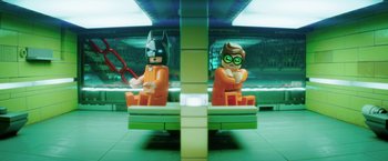Movie still from “The Lego Batman Movie” (2017), directed by Chris McKay – Two lego figures sitting on a bench in a building; Medium shot, Over the shoulder angle