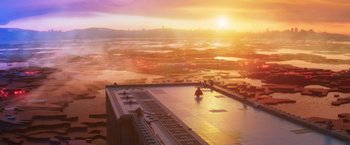 Movie still from “The Lego Batman Movie” (2017), directed by Chris McKay – An aerial view of a city at sunset with the sun setting; Extreme Wide shot, High angle