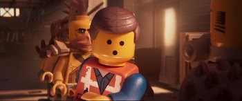 Movie still from “The Lego Movie 2: The Second Part” (2019), directed by Mike Mitchell – A lego man that is sitting in a room; Close Up shot, Over the shoulder angle