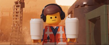 Movie still from “The Lego Movie 2: The Second Part” (2019), directed by Mike Mitchell – A lego man with headphones on; Close Up shot, Low angle
