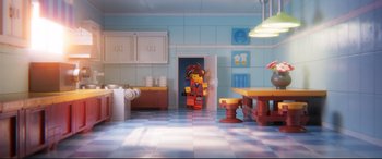 Movie still from “The Lego Movie 2: The Second Part” (2019), directed by Mike Mitchell – A lego character is standing in a kitchen; Wide shot, High angle