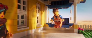 Movie still from “The Lego Movie 2: The Second Part” (2019), directed by Mike Mitchell – A lego man is standing in front of a window; Wide shot, Overhead angle