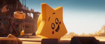 Movie still from “The Lego Movie 2: The Second Part” (2019), directed by Mike Mitchell – A yellow star with a smiling face on it; Close Up shot, Over the shoulder angle