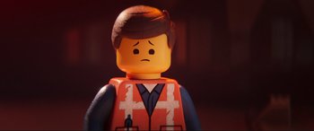 Movie still from “The Lego Movie 2: The Second Part” (2019), directed by Mike Mitchell – A lego man that is wearing an orange vest; Close Up shot, Over the shoulder angle