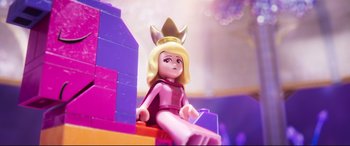 Movie still from “The Lego Movie 2: The Second Part” (2019), directed by Mike Mitchell – A lego figure with a crown on it's head sitting on top of a building; Close Up shot, Over the shoulder angle