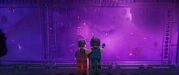 Movie still from “The Lego Movie 2: The Second Part” (2019), directed by Mike Mitchell – A couple of lego people standing next to each other in front of a window; Wide shot, Over the shoulder angle