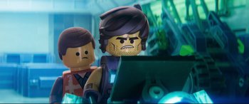 Movie still from “The Lego Movie 2: The Second Part” (2019), directed by Mike Mitchell – Two lego figures are standing next to each other; Close Up shot, Over the shoulder angle