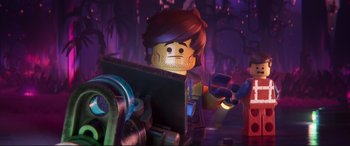 Movie still from “The Lego Movie 2: The Second Part” (2019), directed by Mike Mitchell – A lego character is standing in front of a computer screen; Close Up shot, Over the shoulder angle