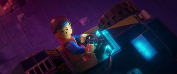 Movie still from “The Lego Movie 2: The Second Part” (2019), directed by Mike Mitchell – A lego man sitting behind a steering wheel in a dark room; Close Up shot, High angle
