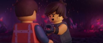 Movie still from “The Lego Movie 2: The Second Part” (2019), directed by Mike Mitchell – Two lego figures are standing next to each other; Close Up shot, Over the shoulder angle