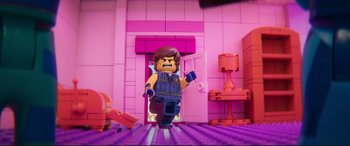 Movie still from “The Lego Movie 2: The Second Part” (2019), directed by Mike Mitchell – A lego character is walking in a pink room; Wide shot, Over the shoulder angle