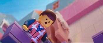 Movie still from “The Lego Movie 2: The Second Part” (2019), directed by Mike Mitchell – A lego man that is standing in front of a building; Close Up shot, Low angle