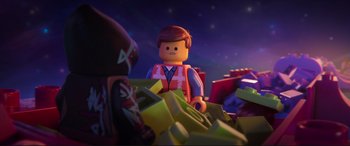 Movie still from “The Lego Movie 2: The Second Part” (2019), directed by Mike Mitchell – A lego man that is sitting on a pile of legos; Close Up shot, Over the shoulder angle