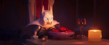 Movie still from “The Lego Movie 2: The Second Part” (2019), directed by Mike Mitchell – A lego batman sitting in front of a bowl of tomatoes; Close Up shot, Over the shoulder angle