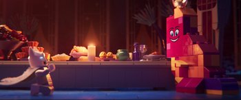 Movie still from “The Lego Movie 2: The Second Part” (2019), directed by Mike Mitchell – A table that has some food on top of it; Wide shot, Over the shoulder angle