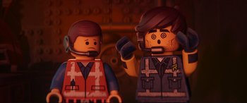 Movie still from “The Lego Movie 2: The Second Part” (2019), directed by Mike Mitchell – Two lego figures are standing next to each other; Close Up shot, Overhead angle