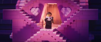 Movie still from “The Lego Movie 2: The Second Part” (2019), directed by Mike Mitchell – A lego figure is standing in a room with pink walls; Medium shot, Over the shoulder angle