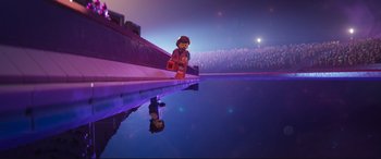 Movie still from “The Lego Movie 2: The Second Part” (2019), directed by Mike Mitchell – A reflection of a person in a pool of water at night; Extreme Wide shot, Over the shoulder angle