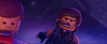 Movie still from “The Lego Movie 2: The Second Part” (2019), directed by Mike Mitchell – A lego character with a microphone in his mouth; Close Up shot, Overhead angle