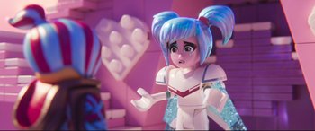Movie still from “The Lego Movie 2: The Second Part” (2019), directed by Mike Mitchell – A toy doll with blue hair and blue eyes; Close Up shot, Over the shoulder angle