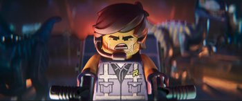 Movie still from “The Lego Movie 2: The Second Part” (2019), directed by Mike Mitchell – A lego character in a suit and tie; Close Up shot, Overhead angle