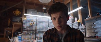 Movie still from “The Lego Movie 2: The Second Part” (2019), directed by Mike Mitchell – A young boy in a plaid shirt is looking at the camera; Close Up shot, Low angle