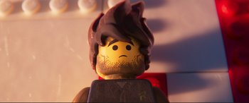 Movie still from “The Lego Movie 2: The Second Part” (2019), directed by Mike Mitchell – An image of a lego man with a sad look on his face; Extreme Close Up shot, High angle