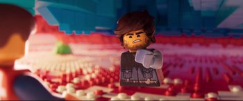 Movie still from “The Lego Movie 2: The Second Part” (2019), directed by Mike Mitchell – A lego character is shown in front of a background of legos; Extreme Close Up shot, High angle
