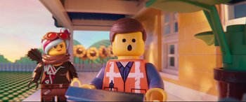 Movie still from “The Lego Movie 2: The Second Part” (2019), directed by Mike Mitchell – A lego man that is sitting in front of some sunflowers; Close Up shot, Over the shoulder angle