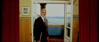 Movie still from “The Life Aquatic with Steve Zissou” (2004), directed by Wes Anderson – An older man standing in front of the ocean; Medium shot, Low angle