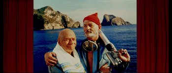 Movie still from “The Life Aquatic with Steve Zissou” (2004), directed by Wes Anderson – Two men are posing for a picture on a boat; Medium shot, Low angle