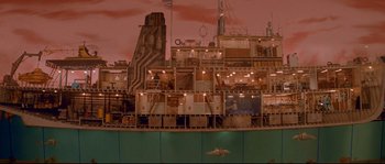 Movie still from “The Life Aquatic with Steve Zissou” (2004), directed by Wes Anderson – A ship with a lot of buildings on top of it; Extreme Wide shot, High angle