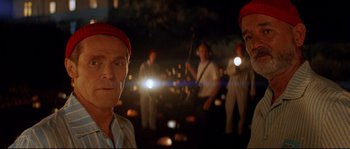 Movie still from “The Life Aquatic with Steve Zissou” (2004), directed by Wes Anderson – A group of men standing in the dark with lights; Close Up shot, Low angle