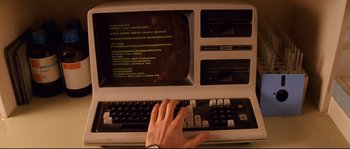 Movie still from “The Life Aquatic with Steve Zissou” (2004), directed by Wes Anderson – A person typing on a computer keyboard; Extreme Close Up shot, Overhead angle