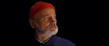 Movie still from “The Life Aquatic with Steve Zissou” (2004), directed by Wes Anderson – An older man with a beard wearing an orange hat; Close Up shot, Low angle