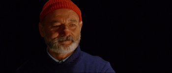 Movie still from “The Life Aquatic with Steve Zissou” (2004), directed by Wes Anderson – An older man wearing a red hat and a blue sweater; Close Up shot, Over the shoulder angle