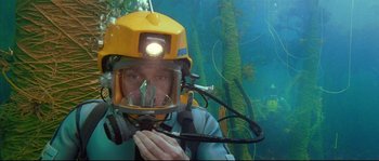 Movie still from “The Life Aquatic with Steve Zissou” (2004), directed by Wes Anderson – A man wearing a diving suit and a diving helmet; Medium shot, Overhead angle