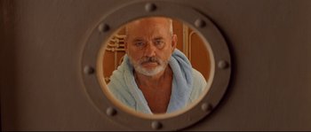 Movie still from “The Life Aquatic with Steve Zissou” (2004), directed by Wes Anderson – An older man with a towel around his neck; Close Up shot, Low angle