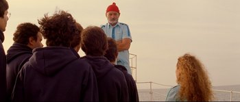 Movie still from “The Life Aquatic with Steve Zissou” (2004), directed by Wes Anderson – An older man wearing a red hat standing on a boat; Medium shot, Over the shoulder angle