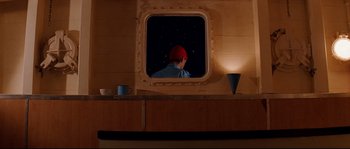 Movie still from “The Life Aquatic with Steve Zissou” (2004), directed by Wes Anderson – A person is looking into a mirror at night; Medium shot, Over the shoulder angle