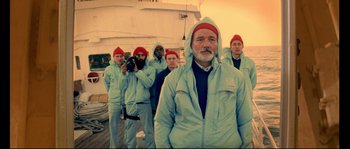 Movie still from “The Life Aquatic with Steve Zissou” (2004), directed by Wes Anderson – A group of men standing next to each other on a boat; Medium shot, Low angle