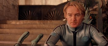 Movie still from “The Life Aquatic with Steve Zissou” (2004), directed by Wes Anderson – A man in a scuba suit sitting on steps; Close Up shot, Over the shoulder angle