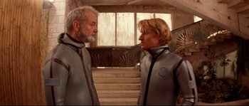 Movie still from “The Life Aquatic with Steve Zissou” (2004), directed by Wes Anderson – A man and a woman in silver suits standing next to each other; Medium shot, Low angle