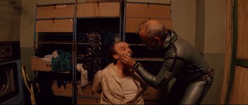 Movie still from “The Life Aquatic with Steve Zissou” (2004), directed by Wes Anderson – A man getting his teeth brushed by another man; Medium shot, Over the shoulder angle